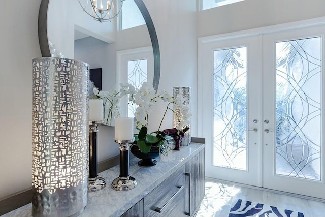 entryway featuring french doors, arched walkways, and wood finished floors