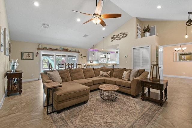 living room with ceiling fan with notable chandelier and high vaulted ceiling