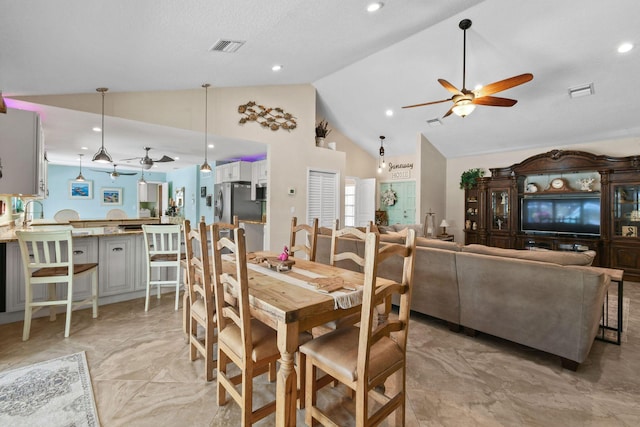 dining space with high vaulted ceiling and ceiling fan