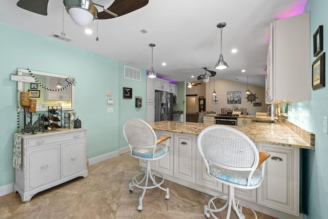 kitchen with white cabinetry, stainless steel refrigerator with ice dispenser, and kitchen peninsula