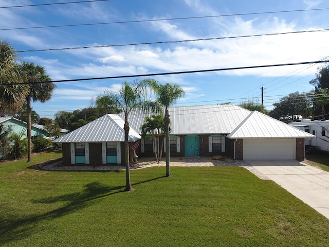 view of front facade with a garage and a front lawn