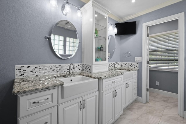 bathroom featuring ornamental molding, vanity, and a wealth of natural light