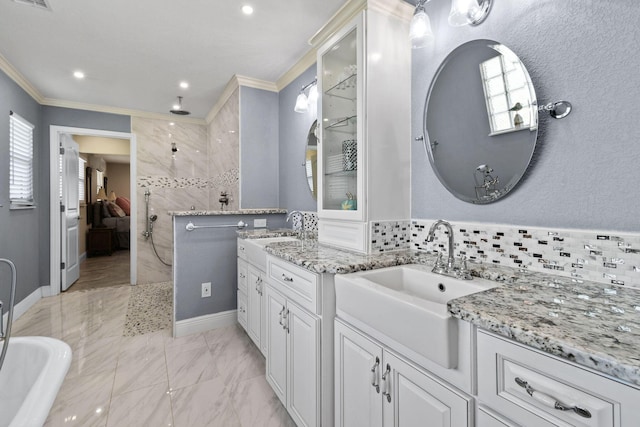 bathroom with tasteful backsplash, ornamental molding, vanity, and tiled shower