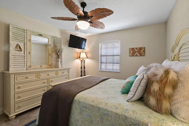 bedroom featuring a textured ceiling and ceiling fan