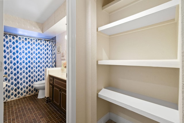 bathroom featuring a shower with curtain, tile patterned floors, vanity, and toilet