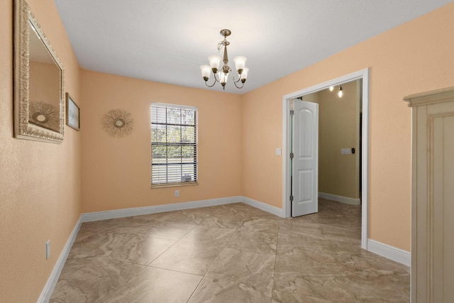 unfurnished room featuring an inviting chandelier