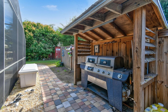 view of patio featuring area for grilling and a lanai