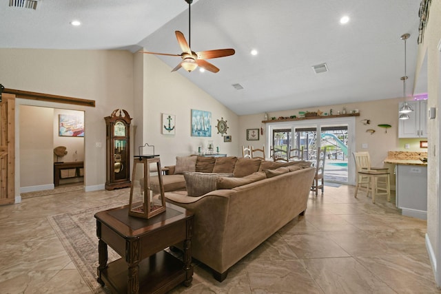 living room with ceiling fan, a barn door, and high vaulted ceiling