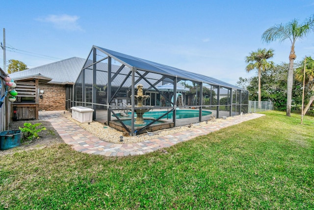 view of pool featuring a yard and a lanai