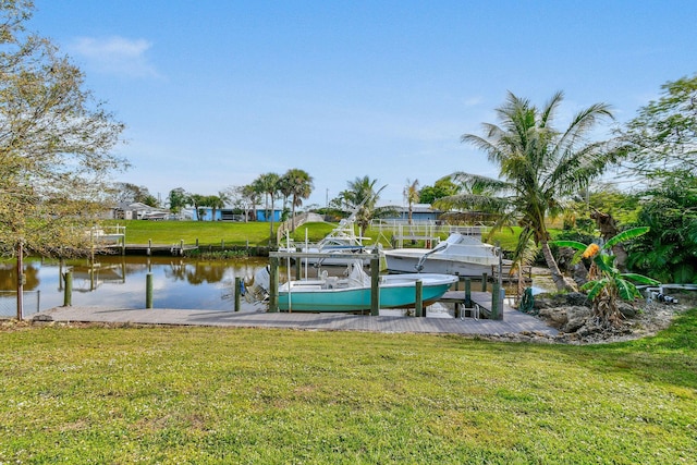 dock area with a water view and a yard