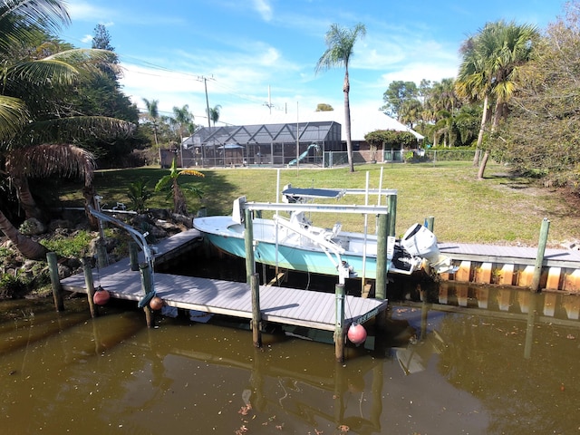 dock area featuring a water view and a yard