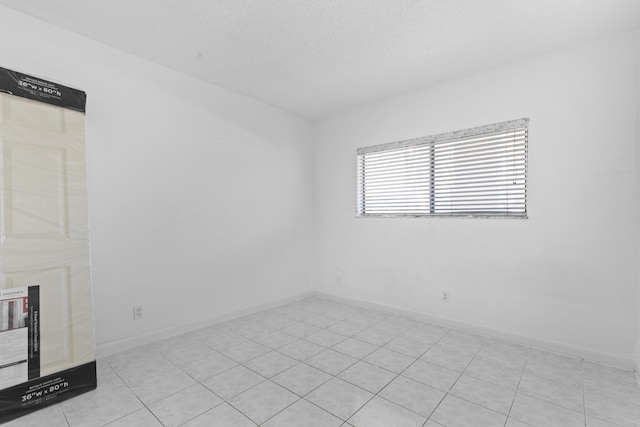 unfurnished room featuring a textured ceiling