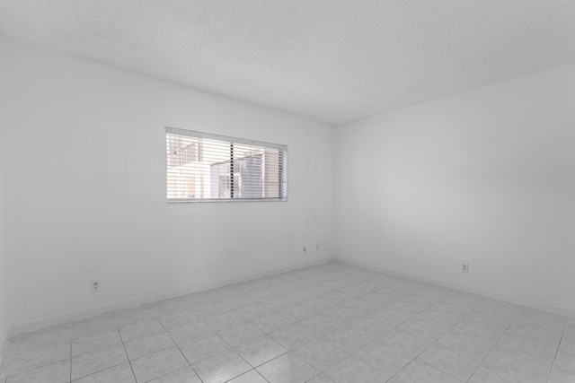 unfurnished room featuring a textured ceiling