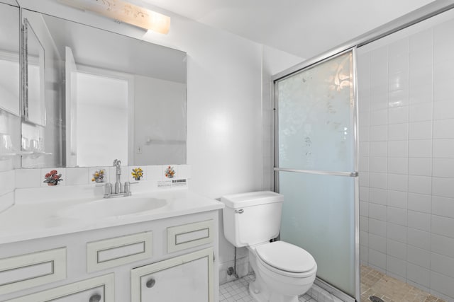 bathroom with vanity, a shower with shower door, and toilet