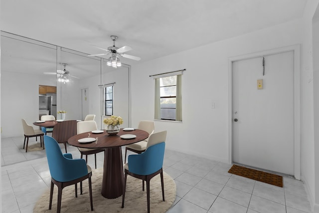 tiled dining room featuring ceiling fan