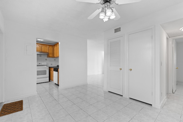 unfurnished living room featuring light tile patterned floors and ceiling fan