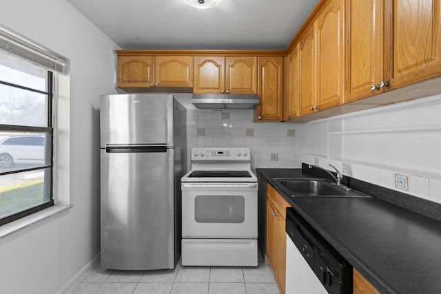 kitchen with tasteful backsplash, sink, white appliances, and light tile patterned floors