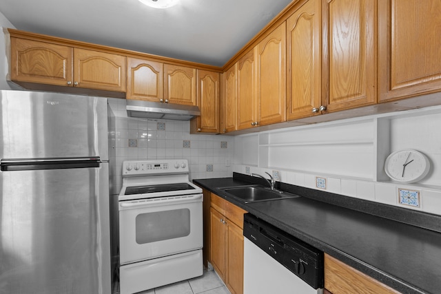 kitchen featuring tasteful backsplash, sink, white appliances, and light tile patterned flooring