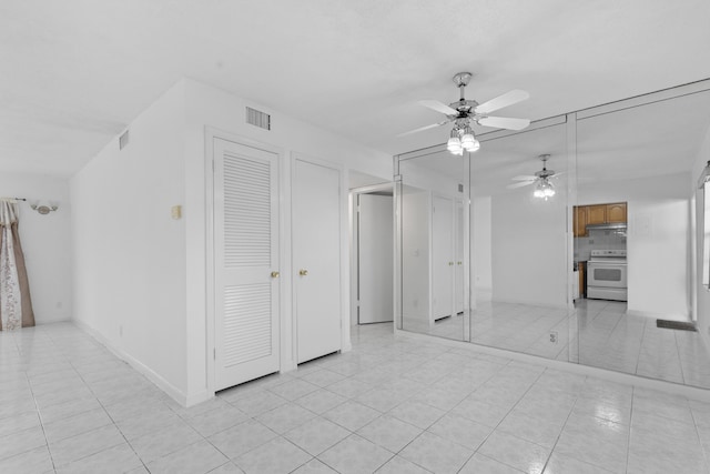 tiled empty room with ceiling fan