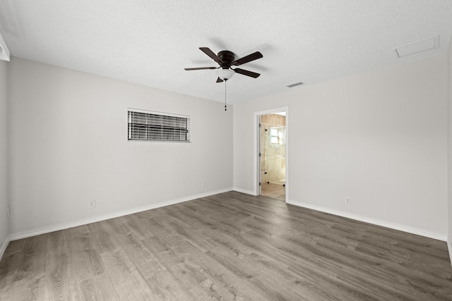 empty room with hardwood / wood-style flooring, ceiling fan, and a textured ceiling