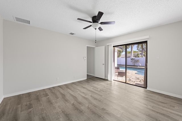 unfurnished room with ceiling fan, a textured ceiling, and light hardwood / wood-style flooring