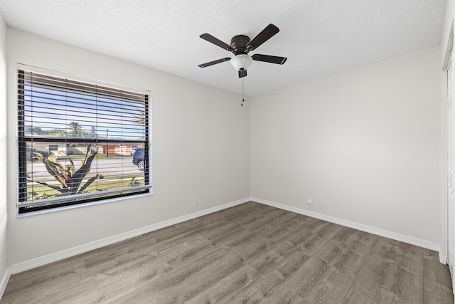 unfurnished room with hardwood / wood-style floors, a textured ceiling, and ceiling fan