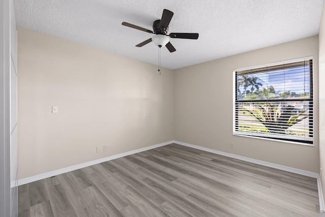 unfurnished room with ceiling fan, a textured ceiling, and light hardwood / wood-style floors