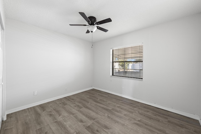 spare room featuring ceiling fan, hardwood / wood-style floors, and a textured ceiling