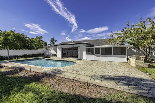 view of pool featuring a patio area and a sunroom