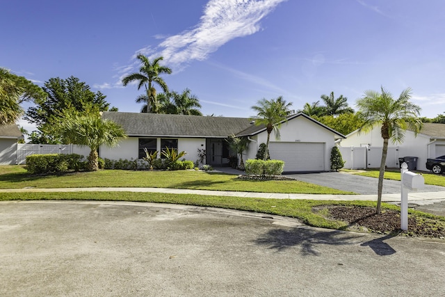 ranch-style house featuring a garage and a front yard