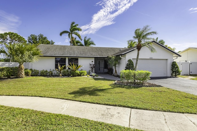 ranch-style home featuring a garage and a front lawn