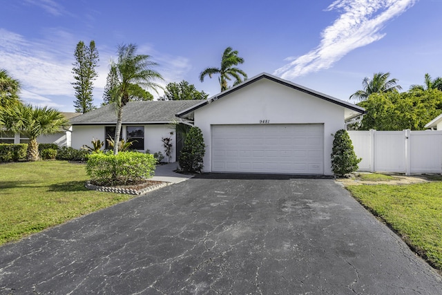 single story home with a garage and a front yard