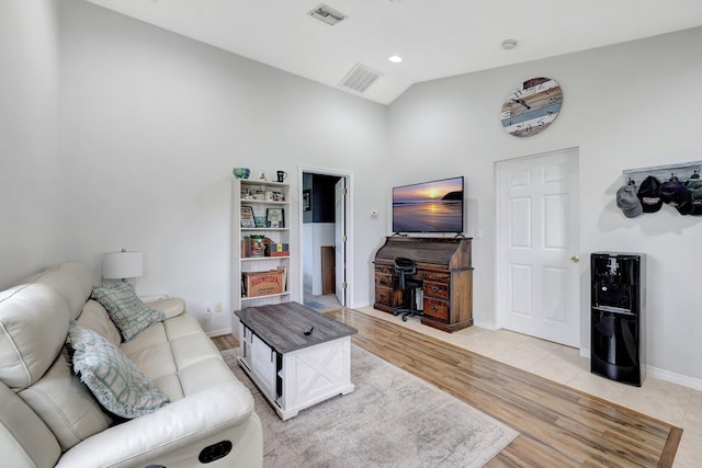 living room with lofted ceiling and light hardwood / wood-style floors