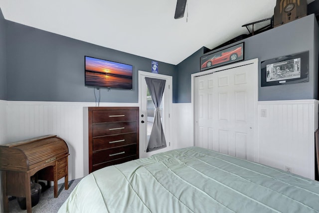 bedroom with ceiling fan, carpet floors, vaulted ceiling, and a closet