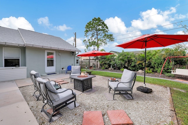 view of patio / terrace featuring a playground and a fire pit