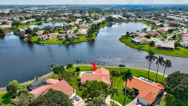 bird's eye view featuring a water view and a residential view