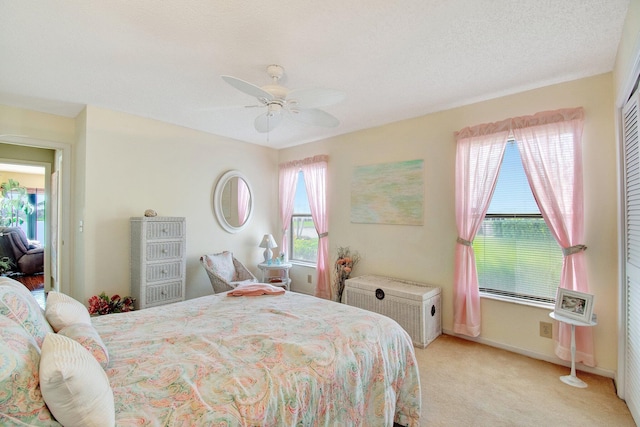 bedroom with a ceiling fan and light carpet