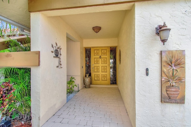 doorway to property with stucco siding