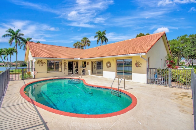 view of swimming pool with a patio, fence, and a fenced in pool