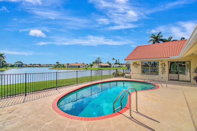 view of swimming pool featuring a patio area and a water view