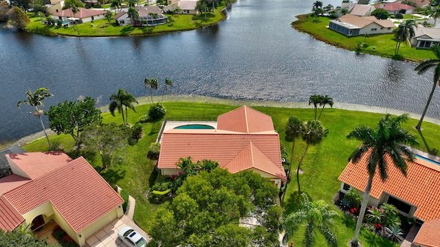 birds eye view of property with a water view and a residential view