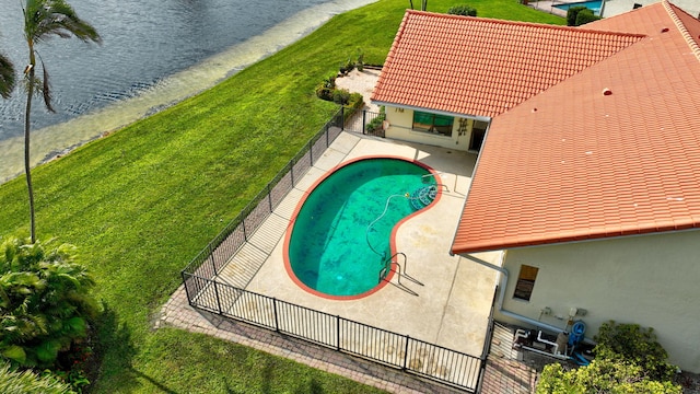 view of swimming pool featuring a patio and fence