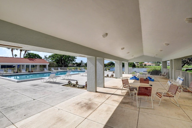 view of patio with a fenced backyard and a community pool