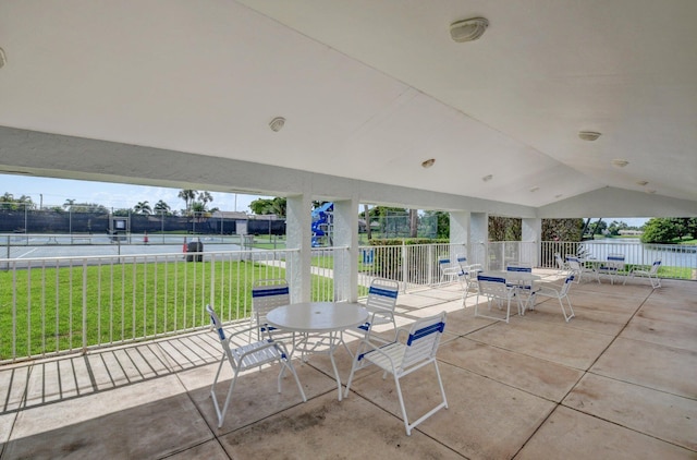 view of patio featuring outdoor dining space and fence