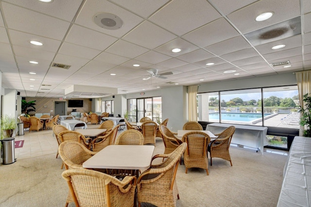 dining area with light colored carpet, a wealth of natural light, and visible vents