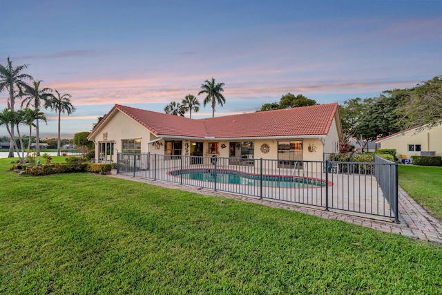 view of pool featuring a fenced in pool, a yard, fence, and a patio