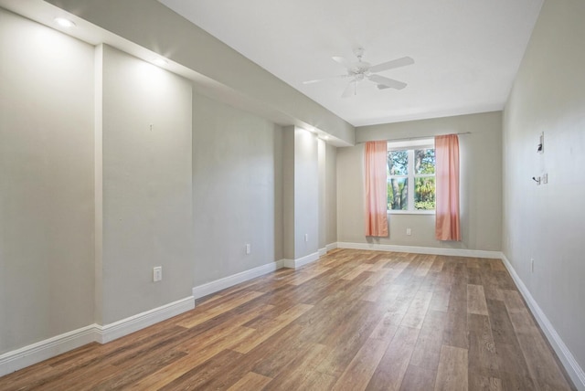 empty room with hardwood / wood-style flooring and ceiling fan