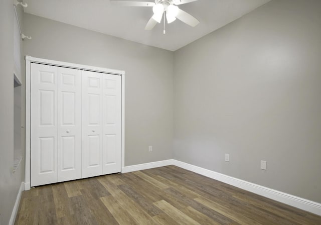 unfurnished bedroom with hardwood / wood-style flooring, a closet, and ceiling fan