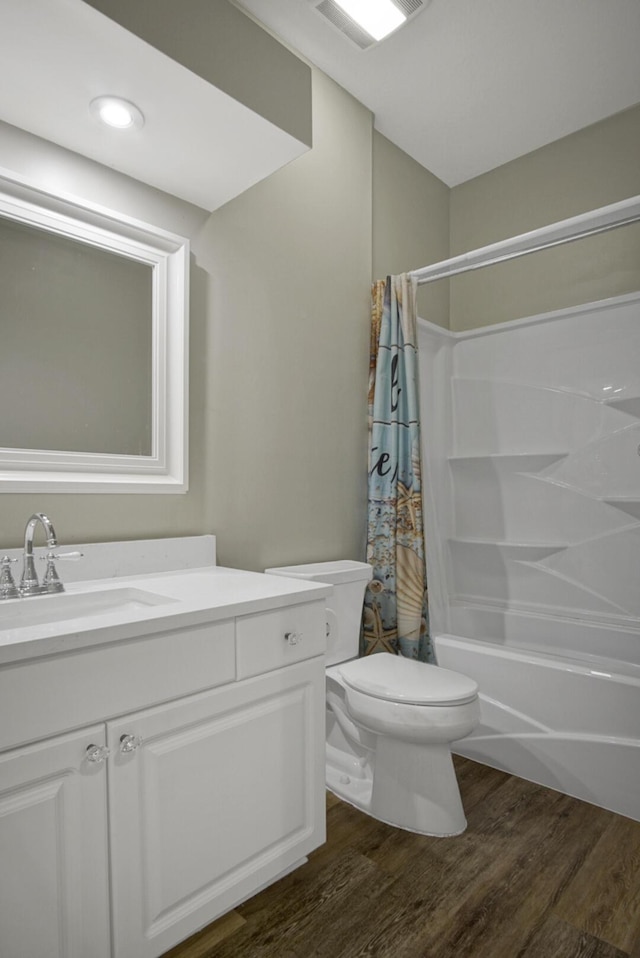 full bathroom featuring shower / tub combo, vanity, toilet, and hardwood / wood-style floors