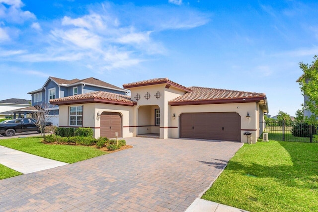 mediterranean / spanish-style home featuring a garage and a front yard